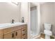 Updated bathroom with a wood vanity, modern sink, and walk-in shower with white tile at 750 E Harbor S Dr, St Petersburg, FL 33705