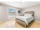 Neutral bedroom with a large window and rustic wood bedframe on tile floor at 750 E Harbor S Dr, St Petersburg, FL 33705