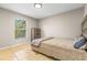 Bright bedroom with neutral walls, tile flooring, and a window for natural light at 750 E Harbor S Dr, St Petersburg, FL 33705