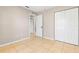 Bedroom featuring neutral-toned walls, tile floors, and a double-door closet at 750 E Harbor S Dr, St Petersburg, FL 33705