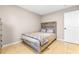 Cozy bedroom featuring light-colored walls, tile flooring, and natural-wood headboard at 750 E Harbor S Dr, St Petersburg, FL 33705