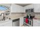 Bright kitchen featuring stainless steel appliances and white cabinetry at 750 E Harbor S Dr, St Petersburg, FL 33705
