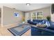 Comfortable living room with tile flooring, a large window, and a stylish blue sectional sofa at 750 E Harbor S Dr, St Petersburg, FL 33705