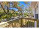 View of a new, natural wood porch and railing overlooking lush green plants and trees at 750 E Harbor S Dr, St Petersburg, FL 33705