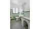 Vintage-style bathroom featuring light tile flooring, fixtures, and window at 801 37Th S Ave, St Petersburg, FL 33705