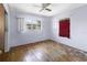 An empty bedroom with hardwood floors, blue walls, and two windows at 801 37Th S Ave, St Petersburg, FL 33705