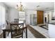 Dining room with chandelier, dark wood table, tile flooring, and stainless steel refrigerator at 801 37Th S Ave, St Petersburg, FL 33705