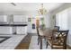Open dining area connecting kitchen, featuring a chandelier and modern decor at 801 37Th S Ave, St Petersburg, FL 33705