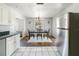 Dining area with view to kitchen, chandelier, and large stainless steel refrigerator at 801 37Th S Ave, St Petersburg, FL 33705