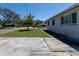 Side view of a house with a tree in the yard, sidewalk, and street at 801 37Th S Ave, St Petersburg, FL 33705