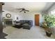 A living room with a fireplace, sectional couch, area rug, ceiling fan, and a potted plant at 801 37Th S Ave, St Petersburg, FL 33705