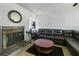 A living room with a fireplace, mirror, sectional couch, area rug, and tile floors at 801 37Th S Ave, St Petersburg, FL 33705