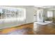 Bright living room with hardwood floors, large window with blinds, and mirrored wall accent at 801 37Th S Ave, St Petersburg, FL 33705