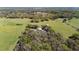 An aerial view shows a expansive property with a mix of grass, woods and multiple buildings at 808 Old Welcome Rd, Lithia, FL 33547
