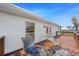 Outdoor back deck featuring chairs, a small table, and a scenic view of the backyard at 808 Old Welcome Rd, Lithia, FL 33547