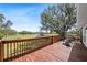 Back deck featuring wood railing with chairs and an expansive view of the backyard at 808 Old Welcome Rd, Lithia, FL 33547