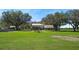 The backyard is sprawling and features large mature trees with an outdoor seating area at 808 Old Welcome Rd, Lithia, FL 33547