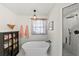 This white bathroom features a stand alone tub, walk in shower, and display cabinet at 808 Old Welcome Rd, Lithia, FL 33547