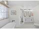 This bright bathroom features a tub, walk-in shower, and a double sink vanity with great lighting at 808 Old Welcome Rd, Lithia, FL 33547