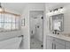 Bright bathroom with a walk-in shower, freestanding tub and a sink vanity with black hardware at 808 Old Welcome Rd, Lithia, FL 33547