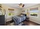 Comfortable bedroom with hardwood floors, large windows, and simple, modern decor at 808 Old Welcome Rd, Lithia, FL 33547