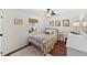 Cozy bedroom with a comfortable bed, neutral decor, hardwood floors, and a window with a backyard view at 808 Old Welcome Rd, Lithia, FL 33547