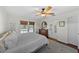 Bright bedroom with ceiling fan, dresser, and sliding doors that lead to an outdoor pool area at 808 Old Welcome Rd, Lithia, FL 33547