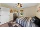 This cozy bedroom has a ceiling fan, dark dresser, and a window letting in natural light at 808 Old Welcome Rd, Lithia, FL 33547