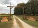 Long driveway flanked by wooden fence decorated with festive fall decor at 808 Old Welcome Rd, Lithia, FL 33547