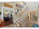 Bright foyer with a wood staircase and an open view of the kitchen with stainless steel appliances at 808 Old Welcome Rd, Lithia, FL 33547