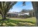 Backyard view of a screened pool and patio area at 808 Old Welcome Rd, Lithia, FL 33547