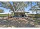 A shed with an outdoor seating area and grill space located in the backyard at 808 Old Welcome Rd, Lithia, FL 33547