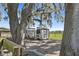 View of the chicken coop showcasing an outdoor run with a metal fence, trees, and a grassy area at 808 Old Welcome Rd, Lithia, FL 33547