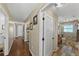 Hallway showing doors to other rooms and the beautifully tiled walk-in shower in the nearby bathroom at 808 Old Welcome Rd, Lithia, FL 33547