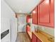 Kitchen showcasing ample red cabinetry, a white refrigerator, and wood countertop at 808 Old Welcome Rd, Lithia, FL 33547