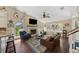Spacious living room with vaulted ceiling, stone fireplace, hardwood floors, and an abundance of natural light at 808 Old Welcome Rd, Lithia, FL 33547