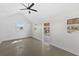 An open living space with plenty of natural light and a ceiling fan is shown at 808 Old Welcome Rd, Lithia, FL 33547