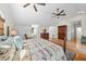 Inviting main bedroom featuring a decorative bed frame, ceiling fans and hardwood floors at 808 Old Welcome Rd, Lithia, FL 33547