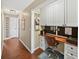Home office nook with white cabinets, desk, and a decorative sign on the wall at 808 Old Welcome Rd, Lithia, FL 33547
