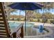 Sparkling screened pool with an umbrella, chairs and lush outdoor views at 808 Old Welcome Rd, Lithia, FL 33547