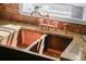 Close-up of a copper sink with a stylish faucet and granite countertop, showcasing the kitchen's elegant design at 808 Old Welcome Rd, Lithia, FL 33547