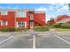 Red brick condo building with well-maintained landscaping and parking space at 8224 11Th N St # A, St Petersburg, FL 33702