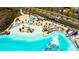Aerial view showcasing the white sand beach area and turquoise water of the community's lagoon at 8261 Ivy Stark Blvd, Wesley Chapel, FL 33545