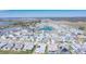 An aerial view showcasing homes within a planned community, with tree lined streets, water features, and green spaces at 8261 Ivy Stark Blvd, Wesley Chapel, FL 33545