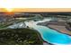 Breathtaking aerial view of a Primary-planned community featuring a stunning lagoon and scenic landscape at 8261 Ivy Stark Blvd, Wesley Chapel, FL 33545