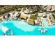Aerial shot features community lagoon with a beach, cabanas and lounge chairs for relaxing by the water at 8261 Ivy Stark Blvd, Wesley Chapel, FL 33545