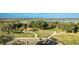 Expansive aerial view featuring the clubhouse, lake, and parking lot, offering a comprehensive overview of the area at 8261 Ivy Stark Blvd, Wesley Chapel, FL 33545