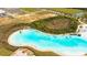 The lagoon at this community features lounge areas and a white sandy beach at 8261 Ivy Stark Blvd, Wesley Chapel, FL 33545