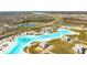 Community aerial showcasing lagoon, beach, and surrounding neighborhood at 8261 Ivy Stark Blvd, Wesley Chapel, FL 33545