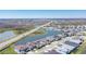 An aerial capture displays a neighborhood alongside winding roads and scenic lakes, highlighting its desirable connectivity at 8261 Ivy Stark Blvd, Wesley Chapel, FL 33545